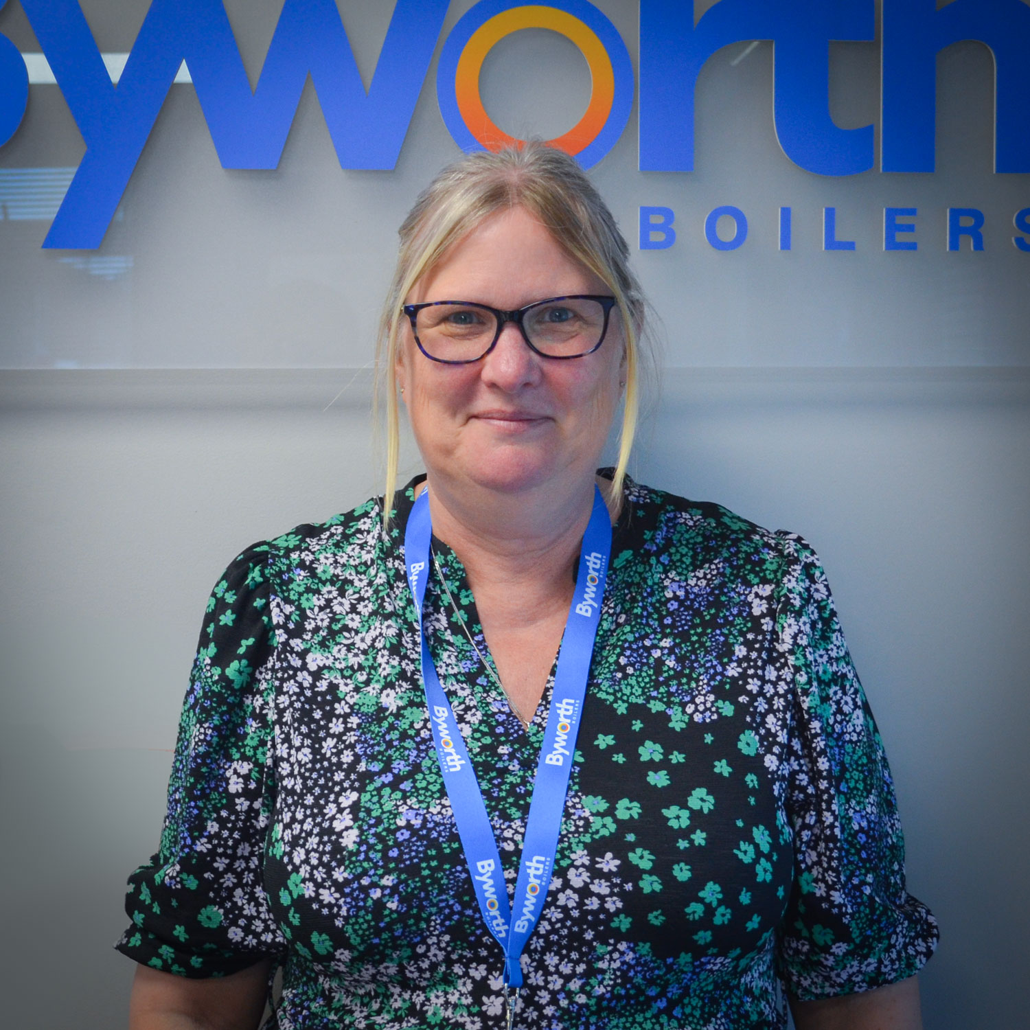 Woman stood in front of a Byworth Boilers sign